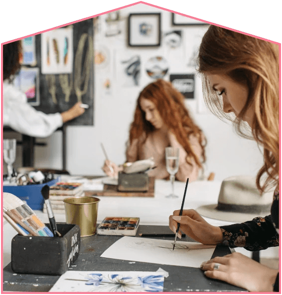 Adults working on art projects together in a studio space